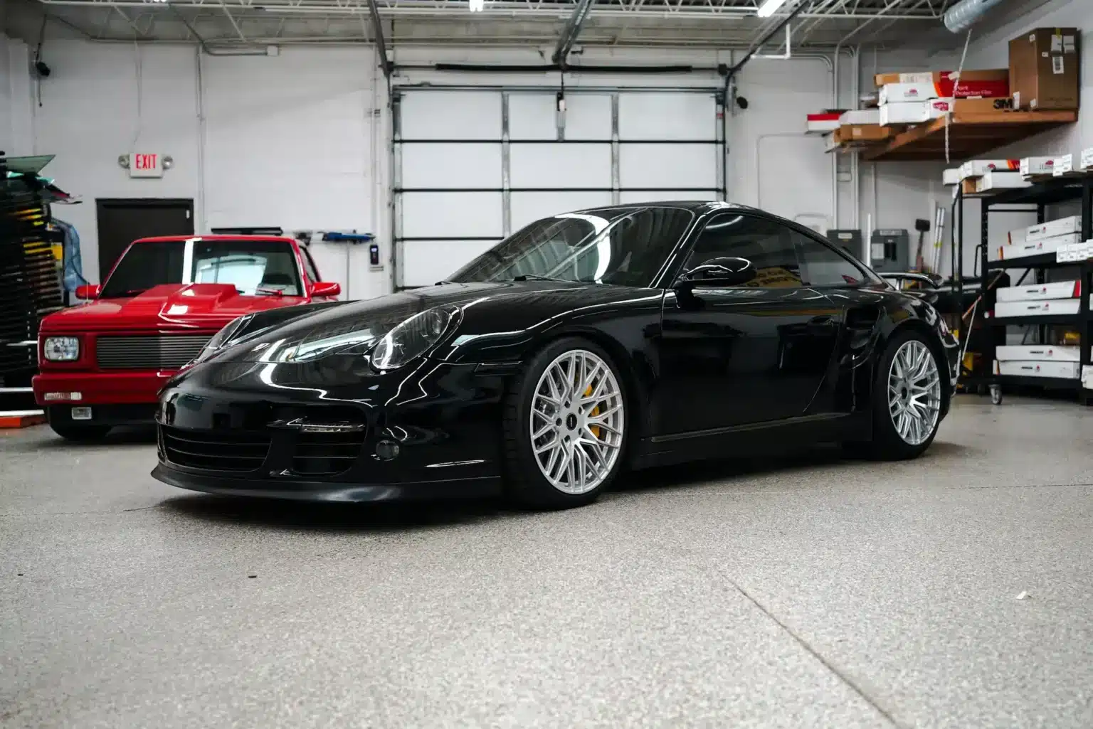 Black Porsche inside the XTREME Addison shop
