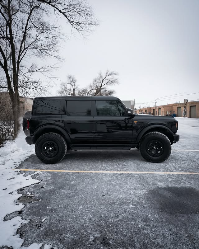 Black Ford Bronco parked in the snow